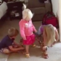 3 kids playing with toy train